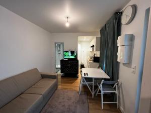a living room with a couch and a table at Appartement F2 Orly Aéroport in Paray-Vieille-Poste