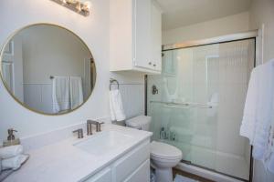 a bathroom with a sink and a toilet and a mirror at 7 beds Relax by Texas Tech & Hospitals Sleeps 10 in Lubbock