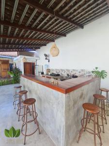 a concrete counter with stools in a kitchen at The Jungle House in Canggu