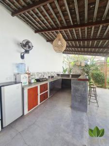 a kitchen with a counter and a refrigerator in it at The Jungle House in Canggu