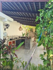 an outdoor kitchen with a blue ceiling and plants at The Jungle House in Canggu