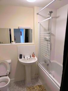 a bathroom with a sink and a toilet and a shower at Centralized Complete 3 BR Flat at Newcastle-Under-Lyme with a View-Free Parking in Newcastle under Lyme