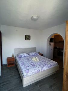 a bedroom with a bed with two towels on it at Apartments Dalibor - 5m from the sea with parking in Lukovo Šugarje