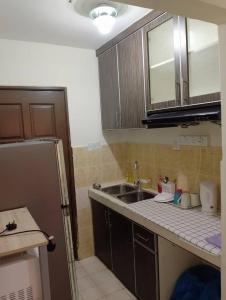 a kitchen with a sink and a counter top at Homestay KTC , Kota Bharu in Kota Bharu