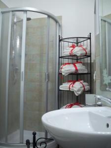 a towel rack in a bathroom with a sink and a shower at Il Terrazzino sul Duomo in Orvieto