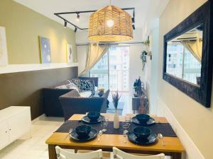 a dining room with a table and chairs and a room at 8 pax Homestay near Axiata Arena & Pavilion 2 in Kuala Lumpur