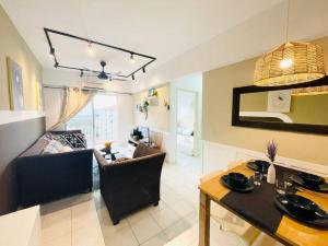 a living room with a table and a dining room at 8 pax Homestay near Axiata Arena & Pavilion 2 in Kuala Lumpur +31 photos