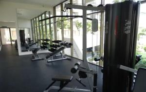 a gym with several treadmills and machines at By The Sea Batu Ferringhi in Batu Ferringhi