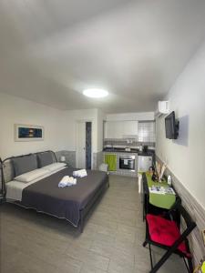 a large bedroom with a bed and a kitchen at Truly Apulia in Bari