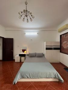 ein Schlafzimmer mit einem großen Bett und einem Deckenventilator in der Unterkunft MINA HOUSE Airport Apartment in Ho-Chi-Minh-Stadt