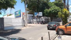 a street with cars parked on the side of the road at Espaço interno in Salvador