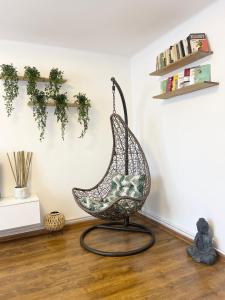 a swing chair sitting in a living room at Buddha's apartment in Cluj-Napoca