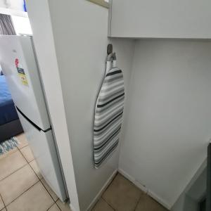 a refrigerator in a kitchen next to a wall at Island Serenity on Magnetic Island in Nelly Bay