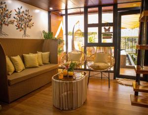 a living room with a couch and a table at Hidden Haven Subic Villa w/ Infinity Pool in Subic