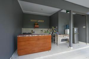a kitchen with a wooden counter and a refrigerator at The Uma Canggu in Canggu
