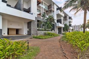 an apartment building with a walkway in front of it at StayVista at Tarika's Seascapes with Pool & Home Theatre in Dabolim