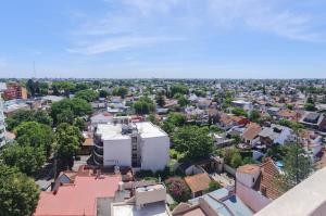 an aerial view of a city with a white building at "EL ESTUDIO" Alquiler Temporario de Departamentos in Mariano J. Haedo