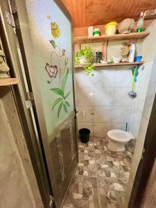 a small bathroom with a toilet in a room at Hunter's Beach House in Boac