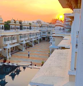 a man standing on a dock in front of a building at Hotel Gautam Lonavala in Lonavala