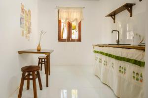 a kitchen with a counter and a sink and stool at The Vibe House - Chillout Hostel in Phu Quoc