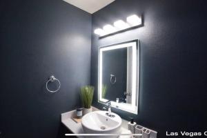 a bathroom with a sink and a mirror at Las Vegas Oasis in Las Vegas