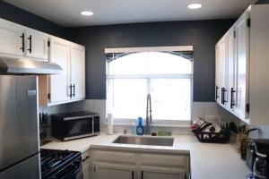 a kitchen with a sink and a microwave and a window at Las Vegas Oasis in Las Vegas