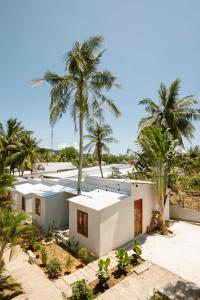 an aerial view of a white house with palm trees at The Vibe House - Chillout Hostel in Phu Quoc