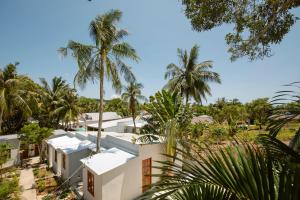 an aerial view of a white house with palm trees at The Vibe House - Chillout Hostel in Phu Quoc