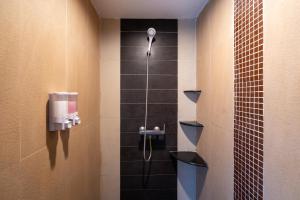 a bathroom with a shower with a shower head at Black Pantera Hostel in Patong Beach