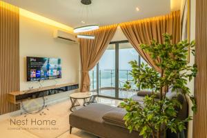 a living room with a couch and a tv at Country Garden Theme Homestay by Nest Home at Danga Bay in Johor Bahru