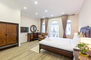 a bedroom with a bed and a living room at L'amour Villa with Sauna at City Center in Da Nang
