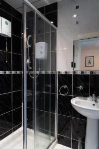 y baño con ducha y lavamanos. en Solihull 5 Bed Home near NEC/Bham airport/JLR/HS2 en Solihull