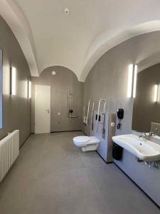 a large bathroom with two sinks and two toilets at Ruttner Ház in Veszprém