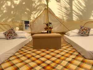 a room with two beds in a tent at INNBOX CAMPSITE in Bolinao