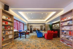 a library with tables and chairs and bookshelves at Sunflower Hotel & Residence, Shenzhen in Shenzhen