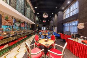 un restaurante con mesas y sillas rojas y un buffet en Sunflower Hotel & Residence, Shenzhen en Shenzhen