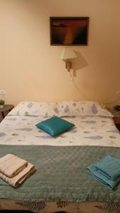 a bed with towels sitting on top of it at Apartments Magda in Cavtat