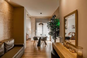 a living room with a table and a mirror at Superior One Luxury Apartments in Thessaloniki