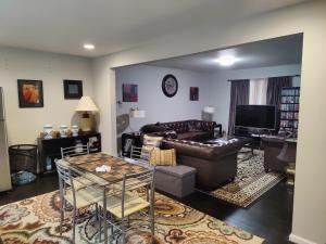 a living room with a couch and a table at Luxurious stay at prime location in Herndon