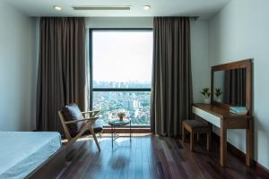 um quarto com uma cama, uma secretária e uma janela em Vinhomes Royal city apartment 3 bed room em Hanói