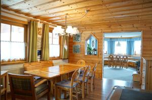 a dining room with a wooden table and chairs at Försterhaus Grossarl in Grossarl