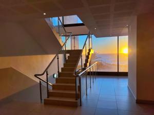 a staircase in a house with a view of the ocean at The Pier no. 7 in Swakopmund