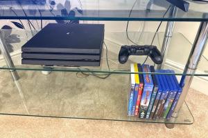 a glass table with a laptop and some books at Salisbury Luxury Apartment in Salisbury