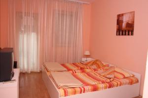 a bedroom with a bed and a tv in it at Villa Greta Pipile in Ohrid +31 photos