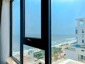 a view of the beach from a window in a building at Paris Deli Danang Beach Hotel in Danang