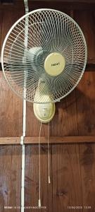 a white fan is hanging on a wooden floor at Chanmuang guesthouse in Mae Hong Son