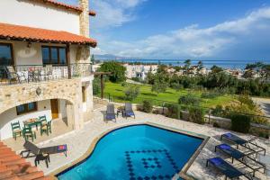 een villa met een zwembad en een patio bij Villa Stefania/pool/garden/sea view/3bdrms/3bthrms in Agia Marina Nea Kydonias