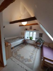 an attic room with a bed and a window at Bølshavnvej5 Bed & Breakfast in Svaneke