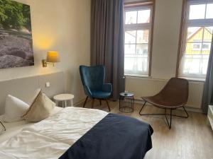 Postel nebo postele na pokoji v ubytování Harzhotel Warnstedter Krug