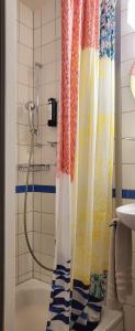 a shower curtain in a bathroom with a tub at Steinenschanze Stadthotel in Basel